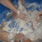 Making a mess mixing up some sand dough